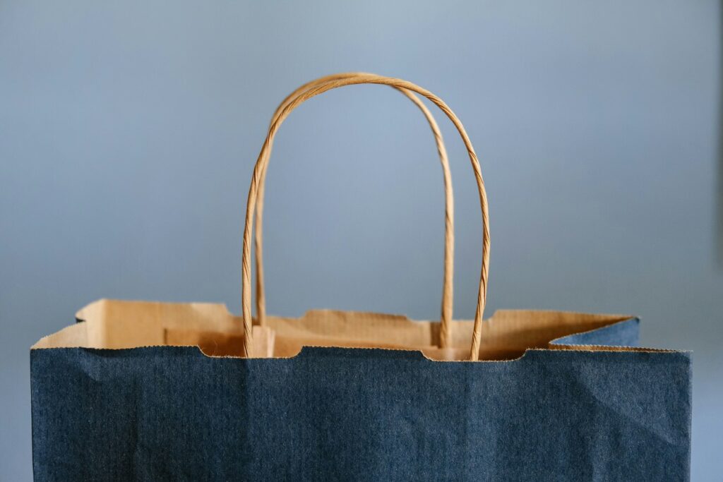 top of dark blue shopping bag with paper handles